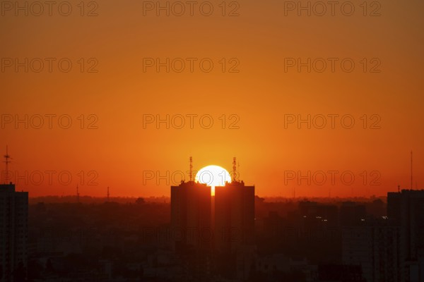 Sunset over skyscrapers in Buenos Aires, symmetry in photography, symbolic image for heat, global