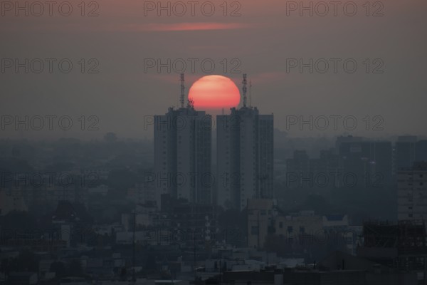 Sunset over skyscrapers in Buenos Aires, symmetry in photography, symbolic image for heat, global