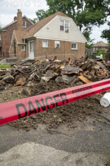 Detroit, Michigan - Signs warn of asbestos danger where a house was demolished. The house had been