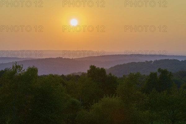 Sunset over wooded hills with orange-coloured sky, peaceful evening mood, Geishöhe, Dammbach,