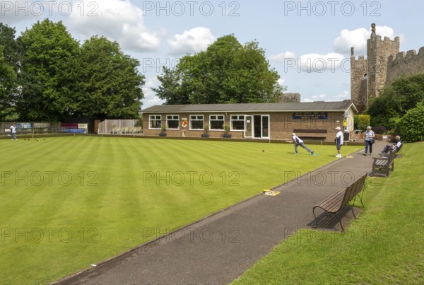 People playing lawn bowls at Framingham Castle bowling club, Suffolk, England, UK