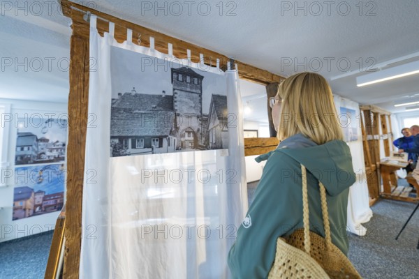 Woman looking at historical photography in a modern designed room, family celebration in Neubulach,