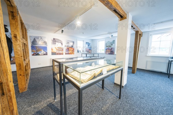 Modern room with photographs and glass showcases, stylish presentation, family celebration in