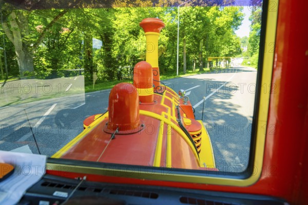View from a train on a green forest road in sunny weather, Calw railway station festival, Black