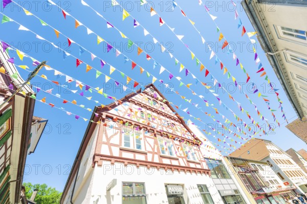Colourfully decorated town with half-timbered houses and colourful flags in summer, Calw station