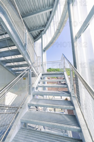 Modern metal staircase structure with glass walls and plenty of daylight, Zob extension with bridge