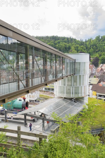 Modern bridge and tower in an urban landscape with hills in the background, Zob extension with