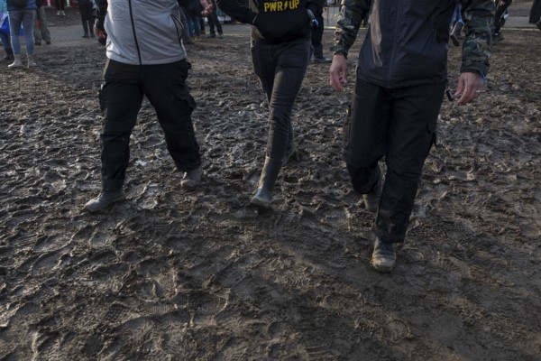 Festival visitors walk through mud in wellies at the Rock am Ring festival on Sunday, Nürburgring