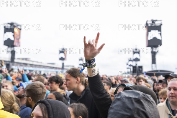 A festival visitor shows the French fries fork at the Rock am Ring Festival on Friday, Nürburgring