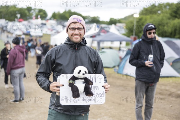 Festival visitor with panda (#Propagandapanda) on a campsite at the Rock am Ring Festival on