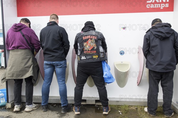 Four gentlemen at Pissiors at the Rock am Ring Festival on Friday, Nürburgring race track race