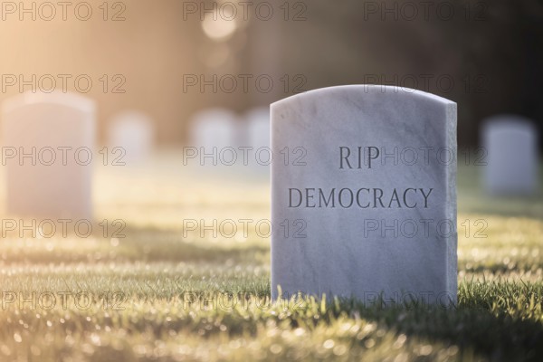 White tombstone in graveyard with text RIP Democracy. Visual metaphor for the decline of democratic