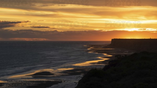 Sunset on the Atlantic coast of Patagonia at Balneario El Condor with the largest parrot colony in