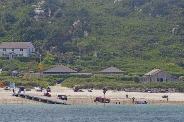 Coastal landscape with beach, houses and green hills in the background, relaxed atmosphere, Isles
