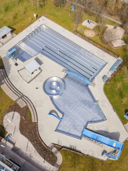 Aerial view of the entire swimming pool area with water slides and green areas, renovation of the