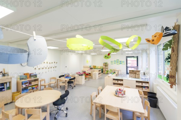 Creatively designed learning space with colourful paper decorations and wooden furniture,