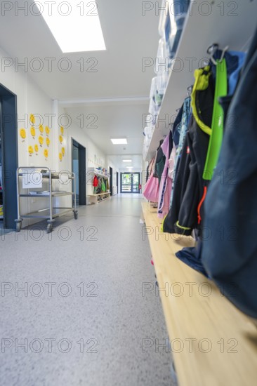Corridor with shelves full of bags and a trolley, bright and organised atmosphere, transitional