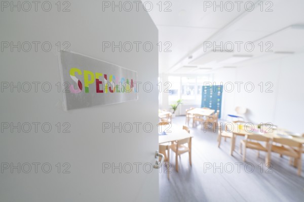 Bright classroom view through an open door with the sign 'Spessart', transitional daycare centre in
