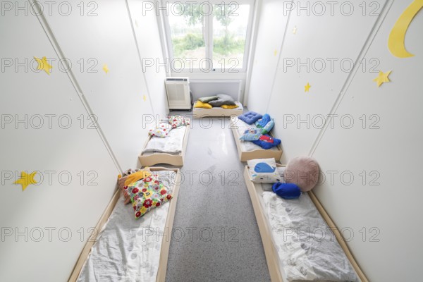 Relaxation room with small beds, soft blankets and decorative elements on the walls, transitional