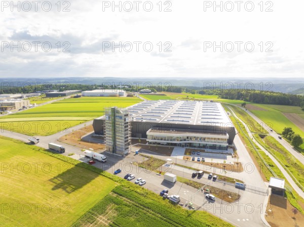 Large industrial facility in a rural setting with vehicles and wide fields, ING Park development