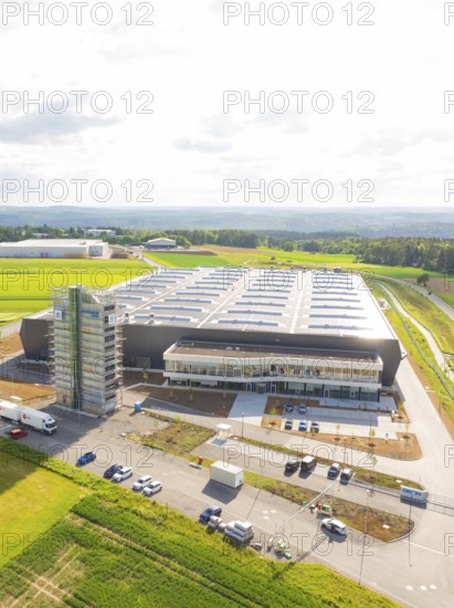 Modern factory complex with large-scale roof construction in a green landscape, ING Park