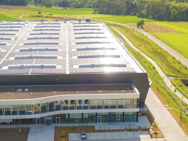 Roof of a large building with solar modules, surrounded by rural landscape, ING Park development