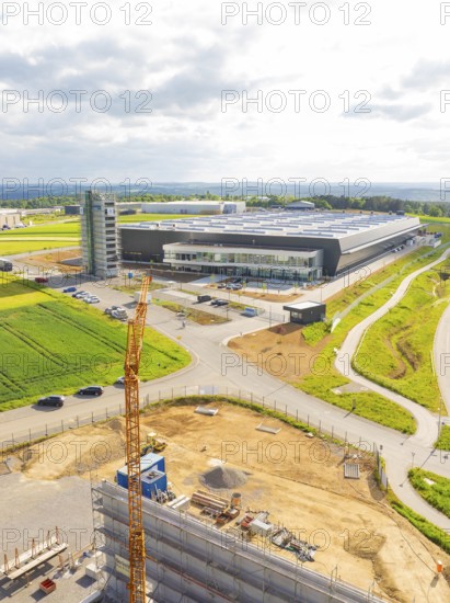 Large industrial building under construction with crane in rural surroundings, ING Park development