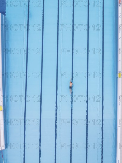 A lone swimmer does his laps in an empty pool, Calw outdoor pool, Black Forest, Germany