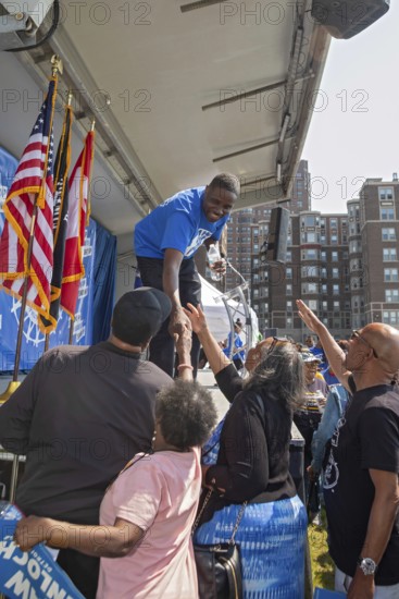 Detroit, Michigan USA - 7 June 2025 - Rev. Solomon Kinloch shakes hands after a rally in which