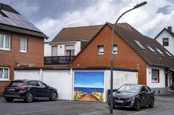 Residential neighbourhood, residential street in Dortmund-Marten, multi-family houses, garages, one