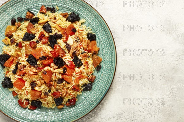 Rice dish, with the addition of dried fruits, nuts and spices of Middle Eastern cuisine, homemade,