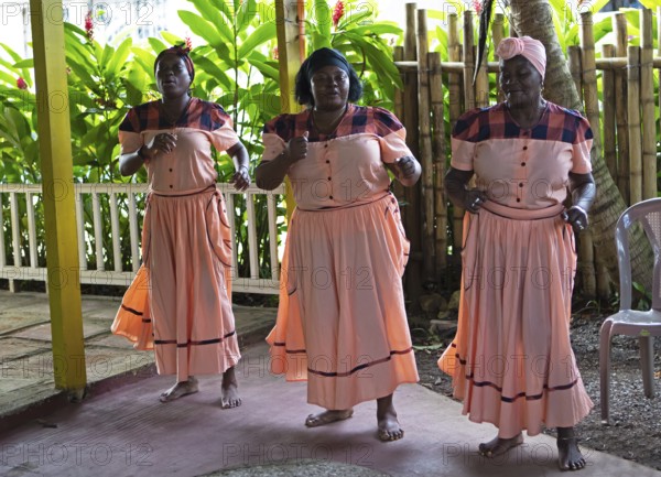 Guatemalan woman in traditional clothing singing and dancing, Garifuna people, Livingston, Izabal