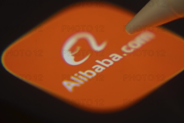 Dhaka, Bangladesh- 06 Dec 2025: Close-up of the Alibaba app on a screen with a stylus pointing at