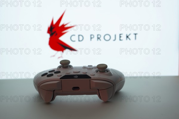 Dhaka, Bangladesh- 08 Apr 2025: A gaming controller in front of a CD Projekt screen