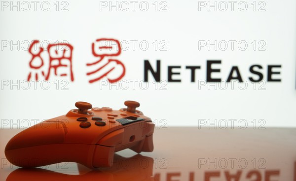 Dhaka, Bangladesh- 20 Mar 2025: A close-up of a gamepad with the NetEase seen on screen in the