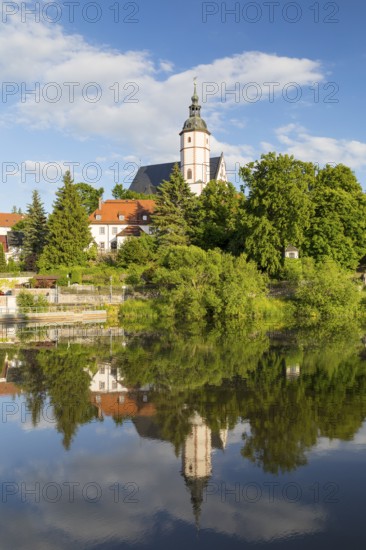 City view with church of Our Lady on the mountains and reflection in Zwickauer Mulde, Penig,