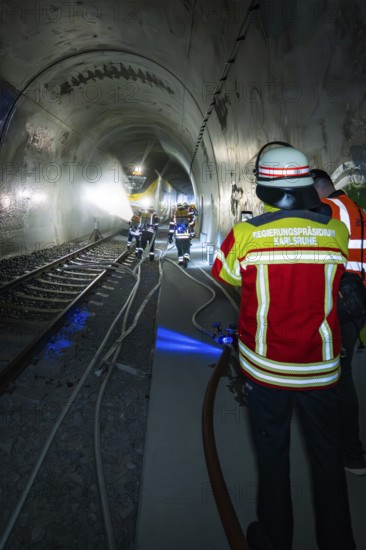Deployment of firefighters in a tunnel with hoses and equipment, fire brigade exercise on the