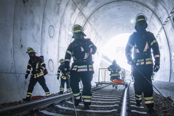 Firefighters in a tunnel working on rails, fire brigade exercise on the Hermann Hesse Railway,