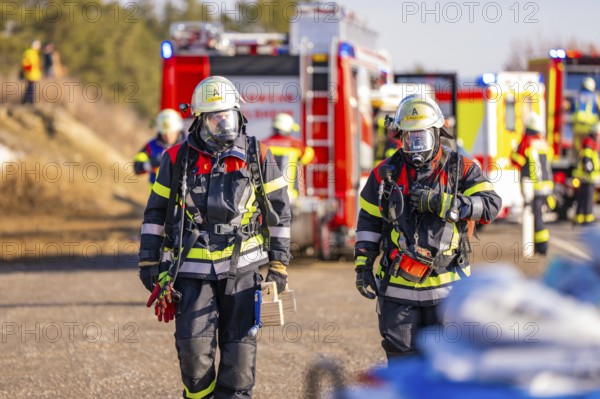 Two firefighters with respirators and full equipment on duty, fire brigade exercise on the Hermann