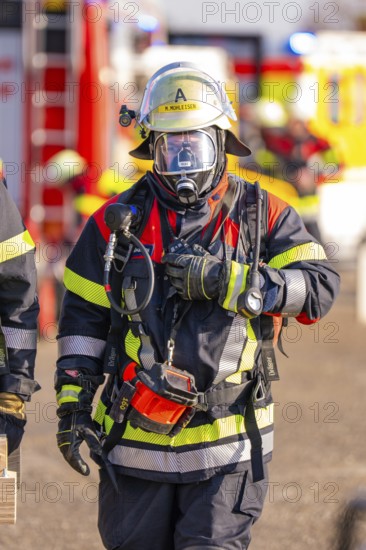 Firefighter wearing full protective clothing during an operation, fire brigade exercise on the