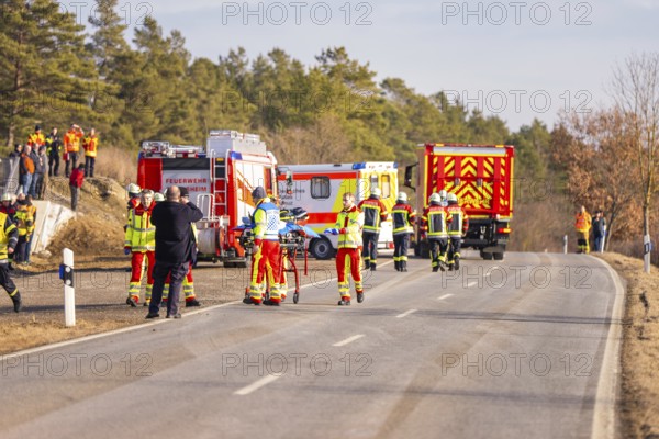 Accident on a country road, fire and emergency services on site with emergency vehicles, fire