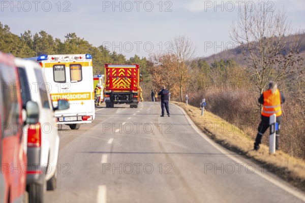Street scene with emergency vehicles and personnel in a wintry landscape, fire brigade exercise on