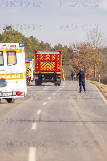 Emergency vehicles and a police officer on a rural road, fire department exercise on the Hermann