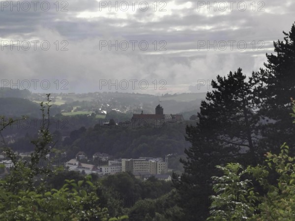Fortress on a hill in fog with a view of a wide landscape, view over Kronach, Frankenwald nature