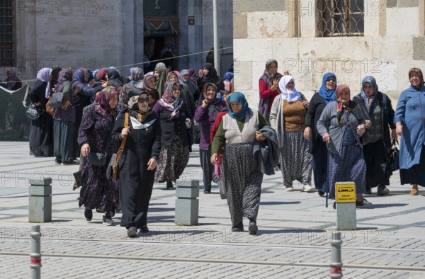 Group of woman in traditional Islamic dress in a square, woman after prayer at Konya Sultan Selim
