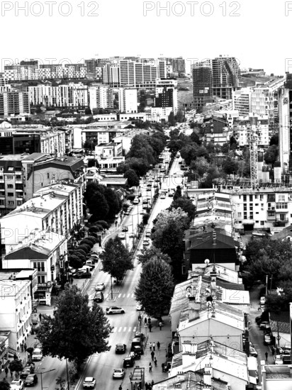 Aerial view of an urban environment with high-rise buildings and roads in black and white,