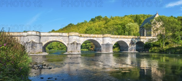 13th century medieval stone bridge across the Werra river, in the back the Liborius chapel,