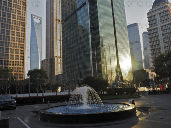 Skyscrapers with reflective glass facades and a fountain in the city center, Pudong, Shanghai,