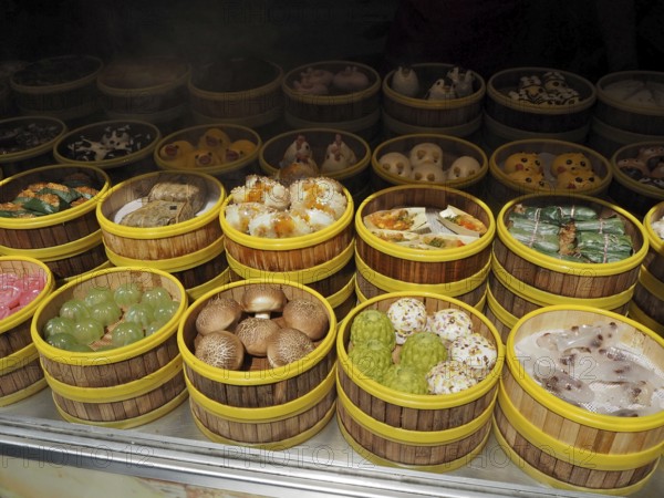 Different types of dim sum carefully arranged in bamboo steamers at a wet market, French