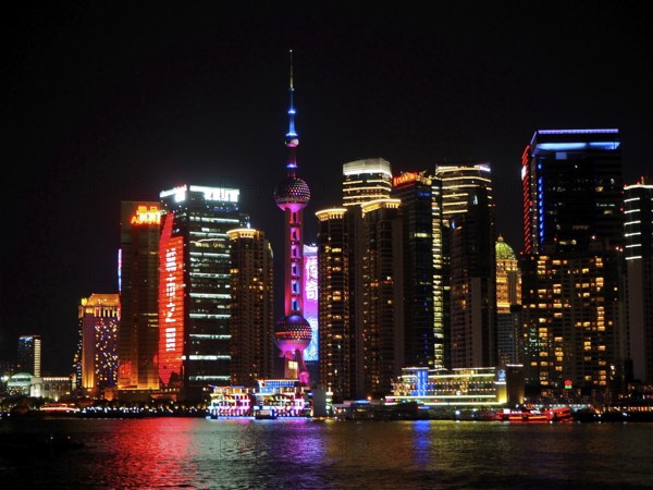 Illuminated skyline with the iconic Oriental Pearl Tower shining in the light at night, Shanghai,
